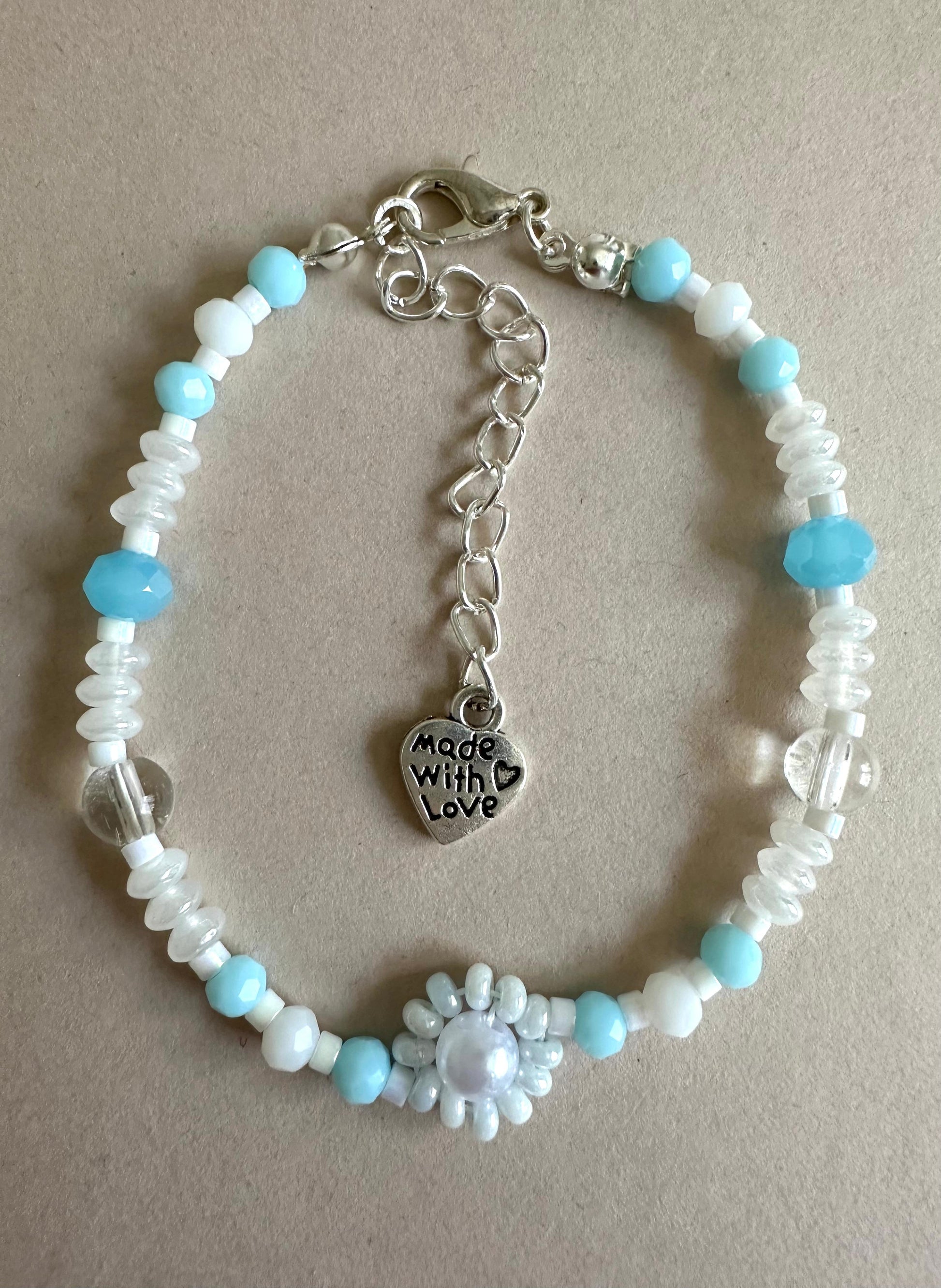 Ocean Mist handmade bracelet with light blue and white glass beads, faux pearl, and beaded flower design
