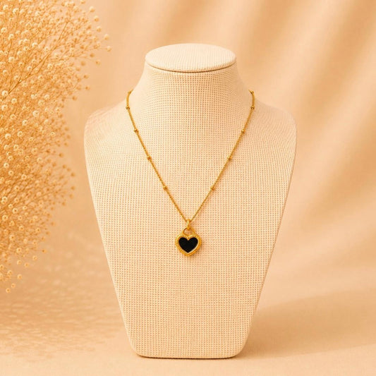 Gold stainless steel reversible heart necklace with black and white pendant on chain