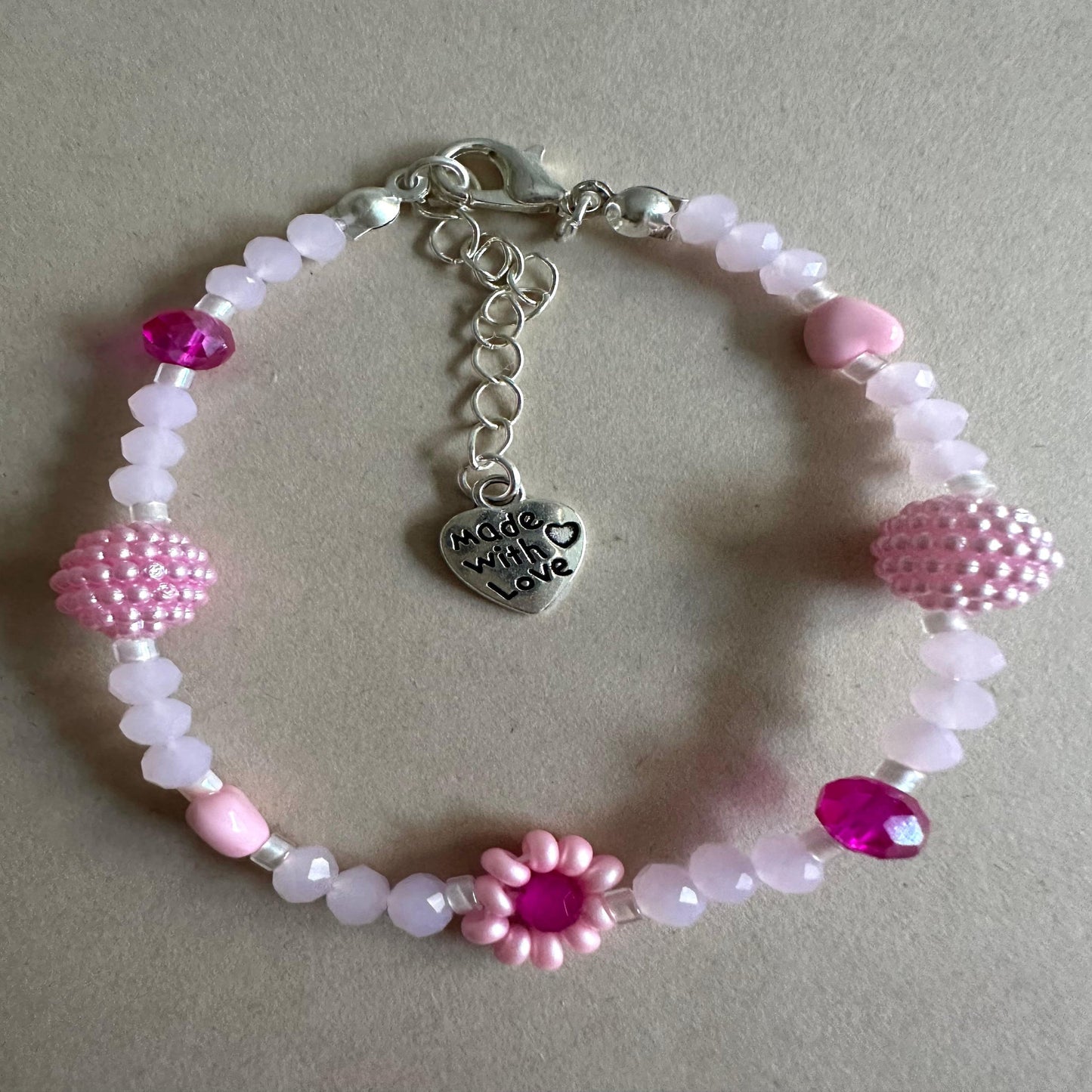 Handmade blush tone bracelet with pink and fuchsia glass beads and faux pearls