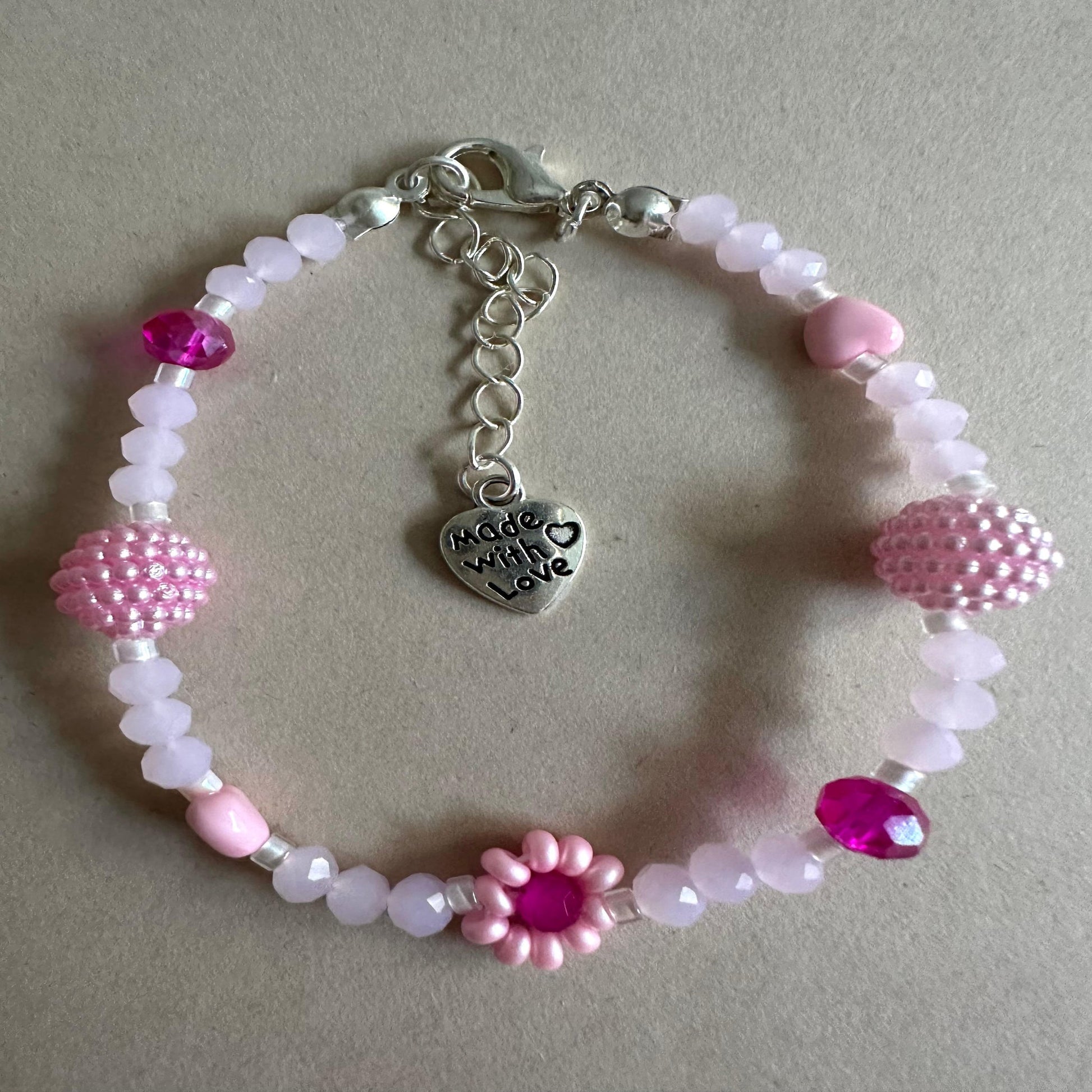 Handmade blush tone bracelet with pink and fuchsia glass beads and faux pearls