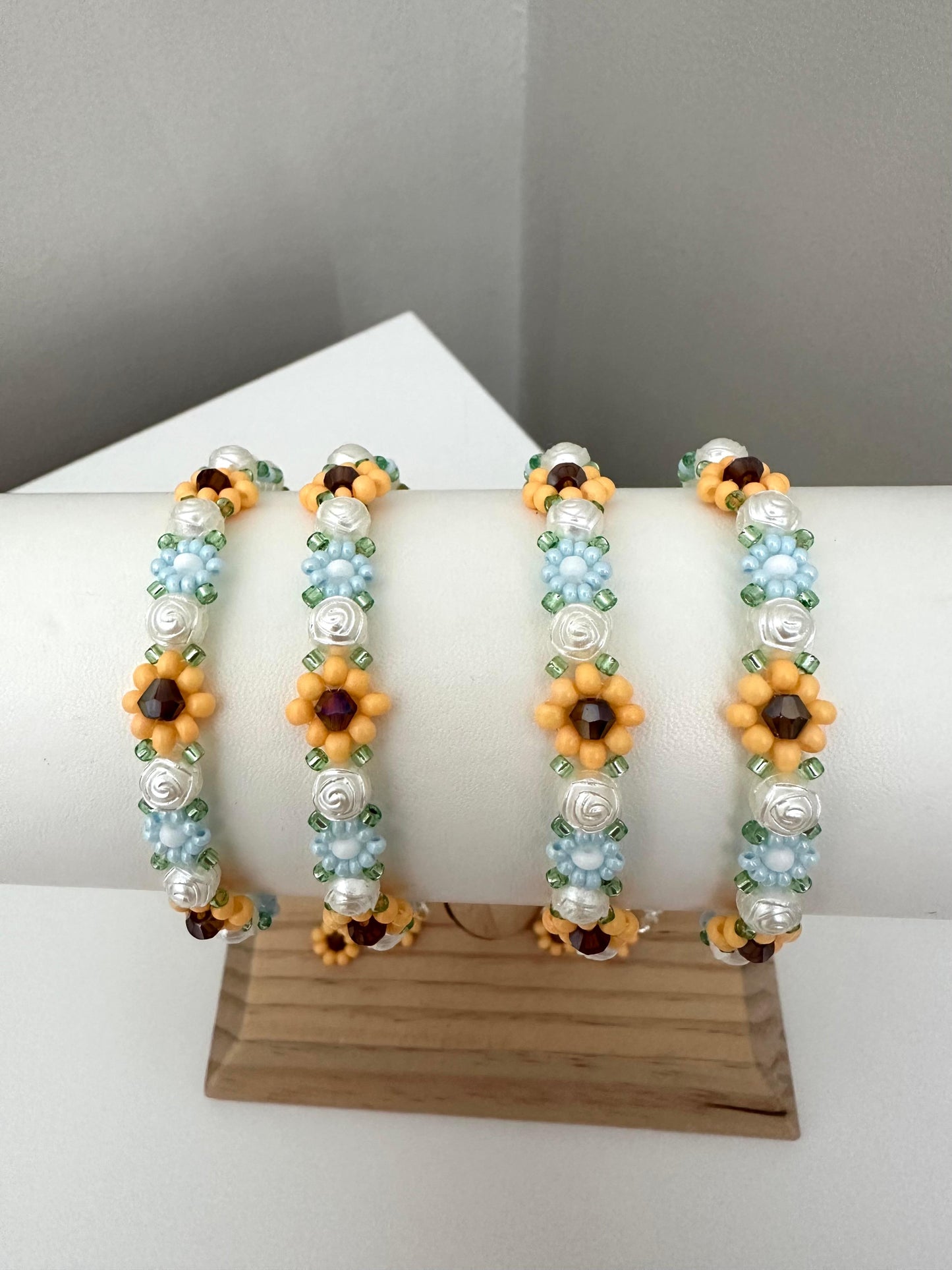 Elegant Floral Bloom handmade bracelet with blue, white, orange beads and rose-shaped faux pearls on nylon string