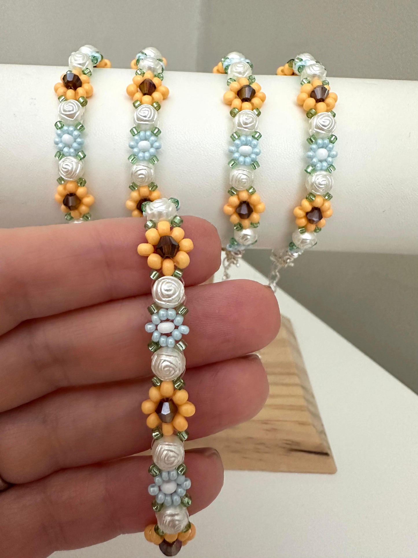 Elegant Floral Bloom handmade bracelet with blue, white, orange beads and rose-shaped faux pearls on nylon string