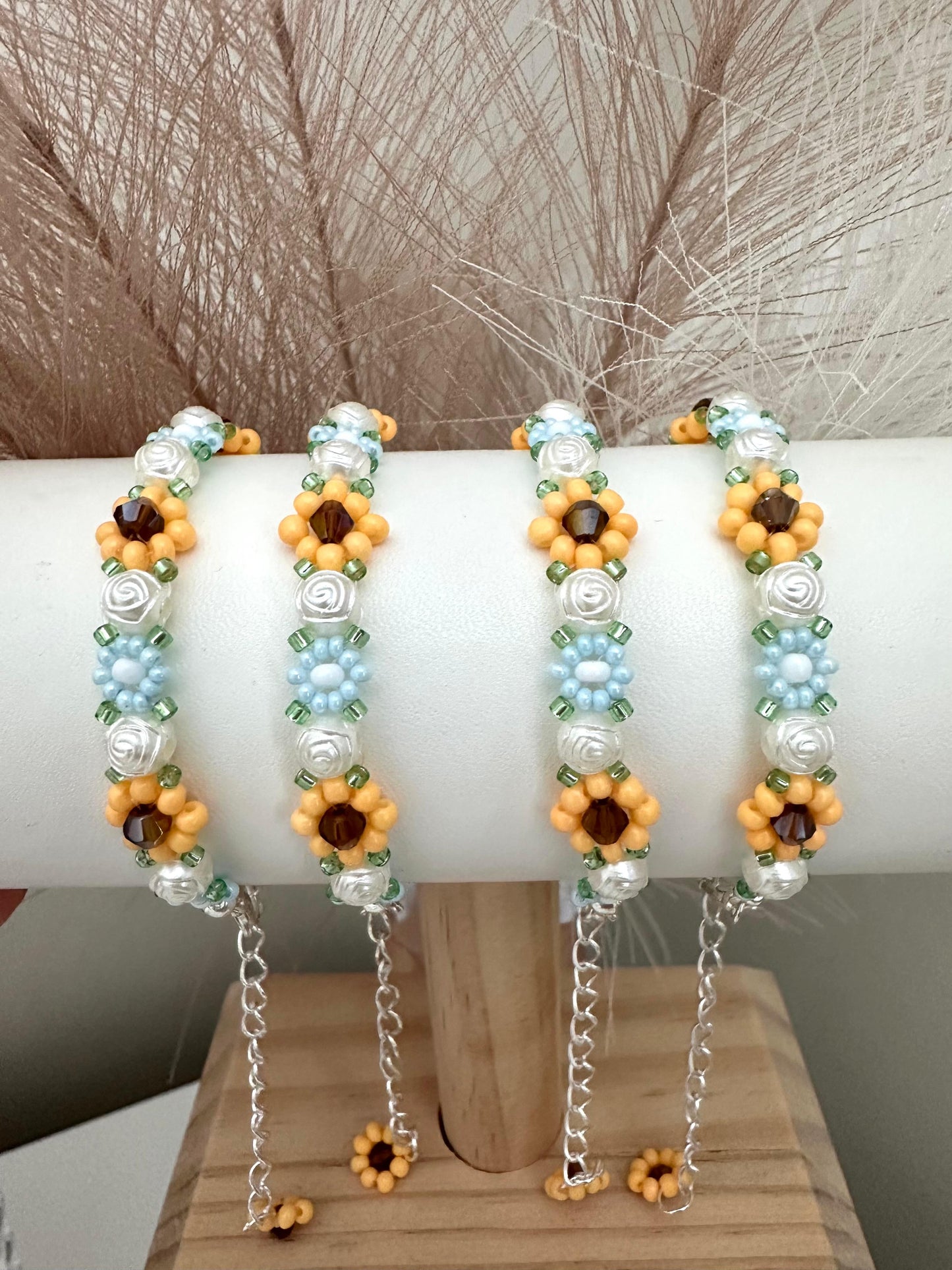 Elegant Floral Bloom handmade bracelet with blue, white, orange beads and rose-shaped faux pearls on nylon string