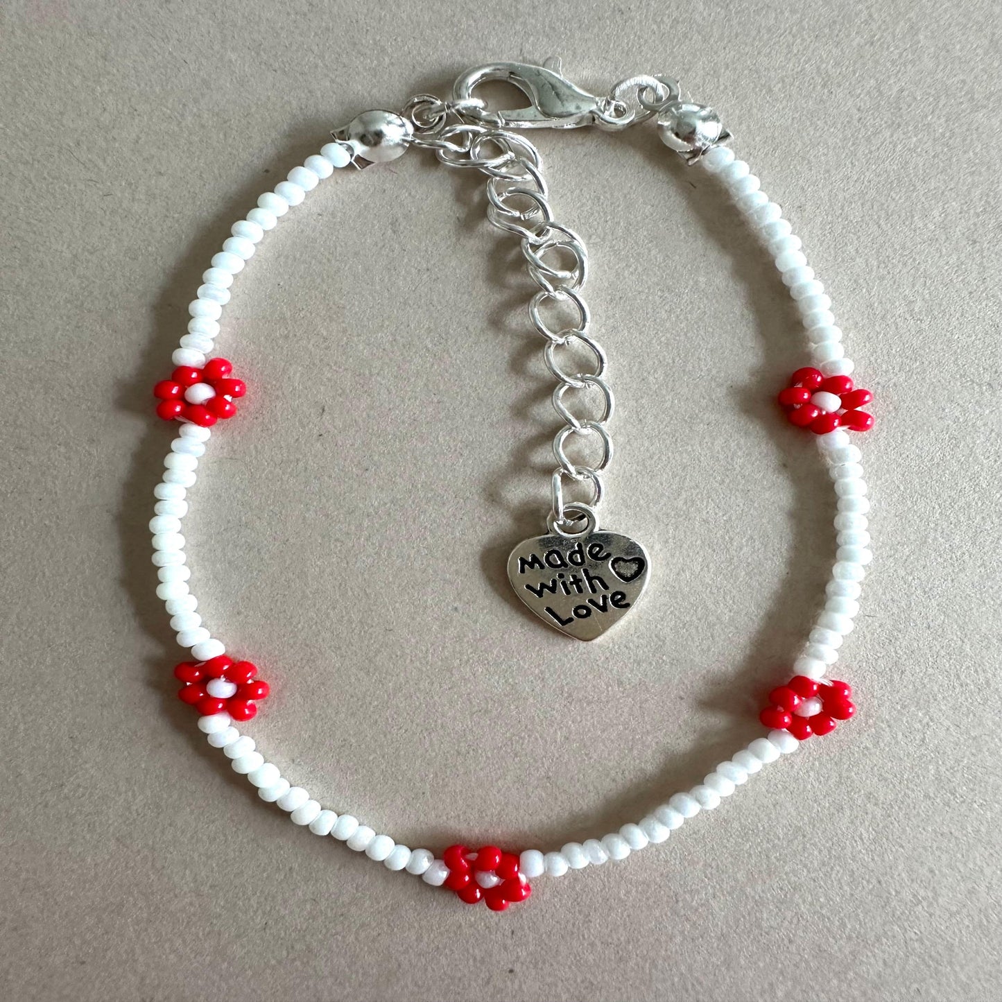 RED BLOOM DELIGHT Handmade Bracelet with white glass beads and red flower accents, stainless steel clasp, 6.7-inch length with extender