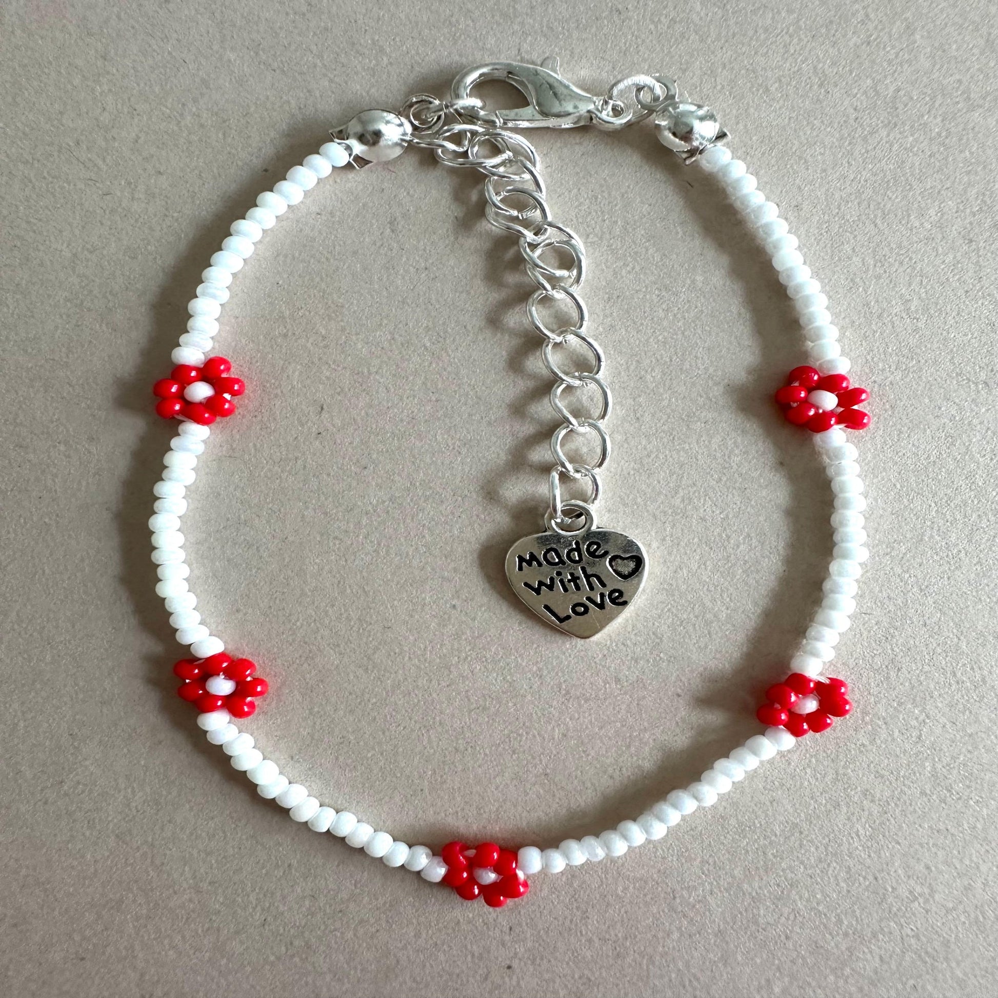 RED BLOOM DELIGHT Handmade Bracelet with white glass beads and red flower accents, stainless steel clasp, 6.7-inch length with extender