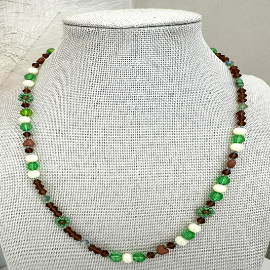 Handmade MORNING DEW necklace with brown and green glass beads and floral details on stainless steel chain