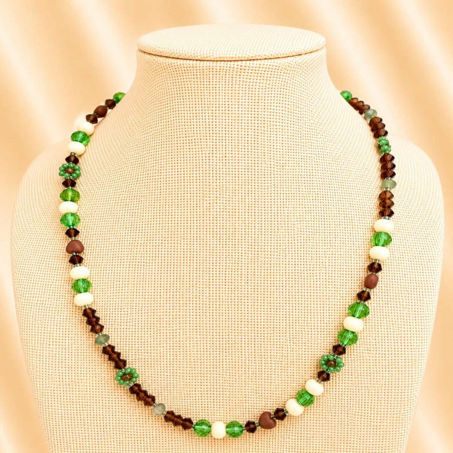 Handmade MORNING DEW necklace with brown and green glass beads and floral details on stainless steel chain