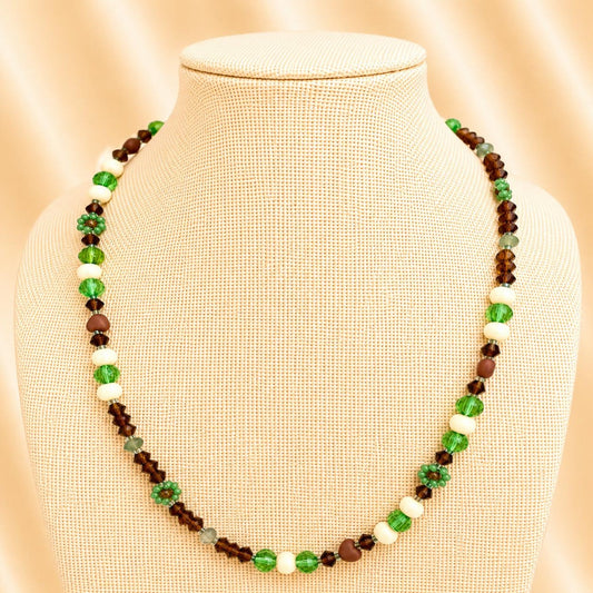 Handmade MORNING DEW necklace with brown and green glass beads and floral details on stainless steel chain