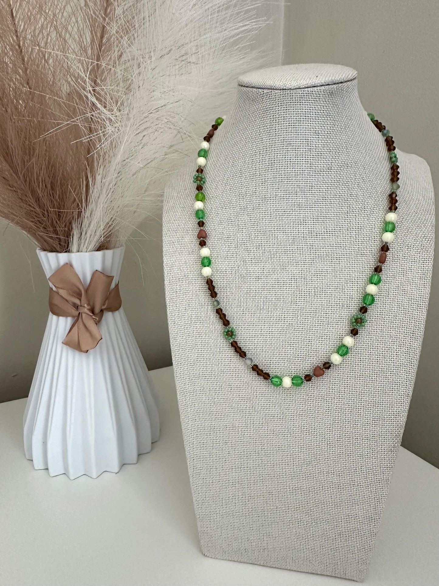 Handmade MORNING DEW necklace with brown and green glass beads and floral details on stainless steel chain