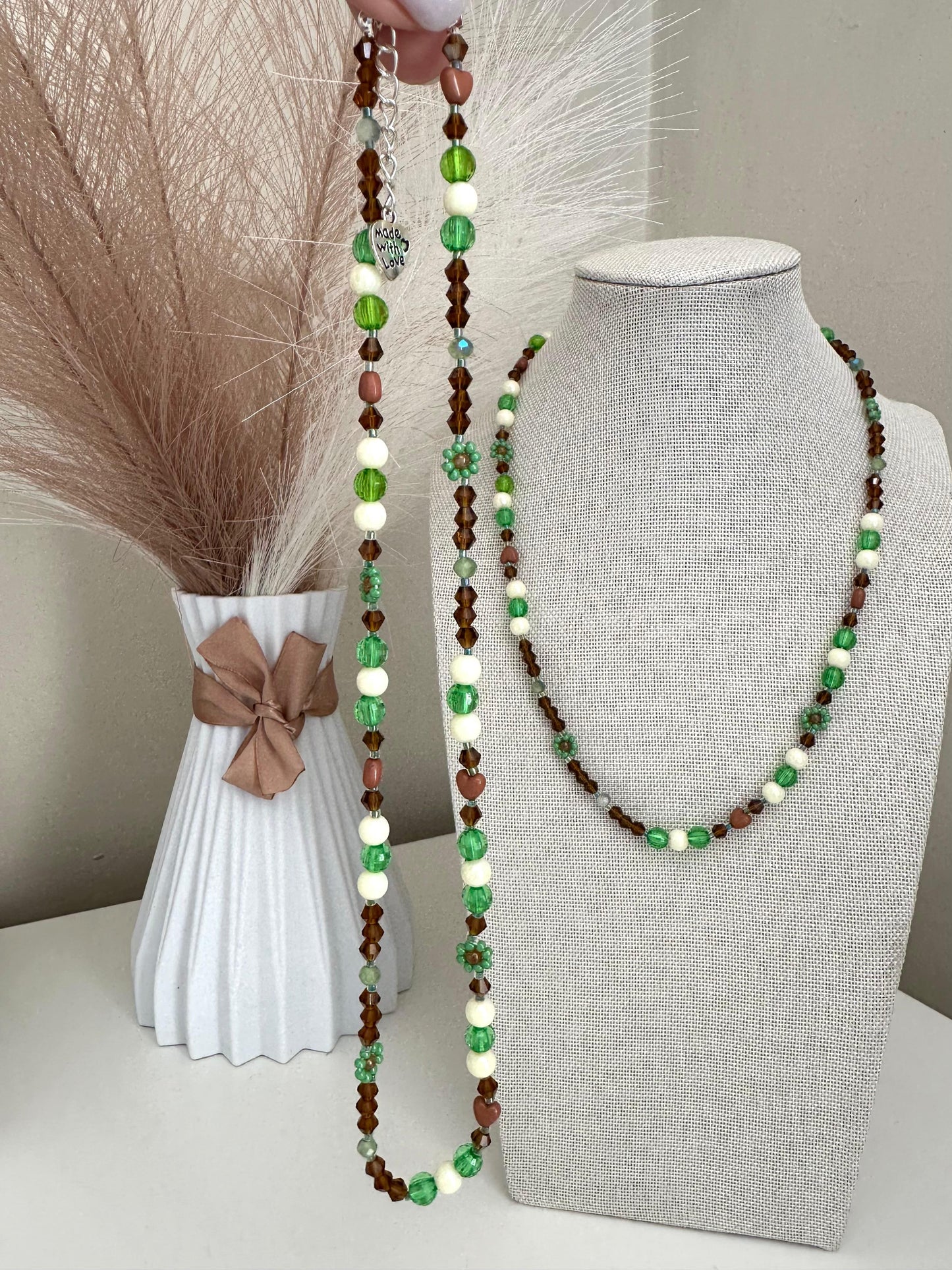 Handmade MORNING DEW necklace with brown and green glass beads and floral details on stainless steel chain