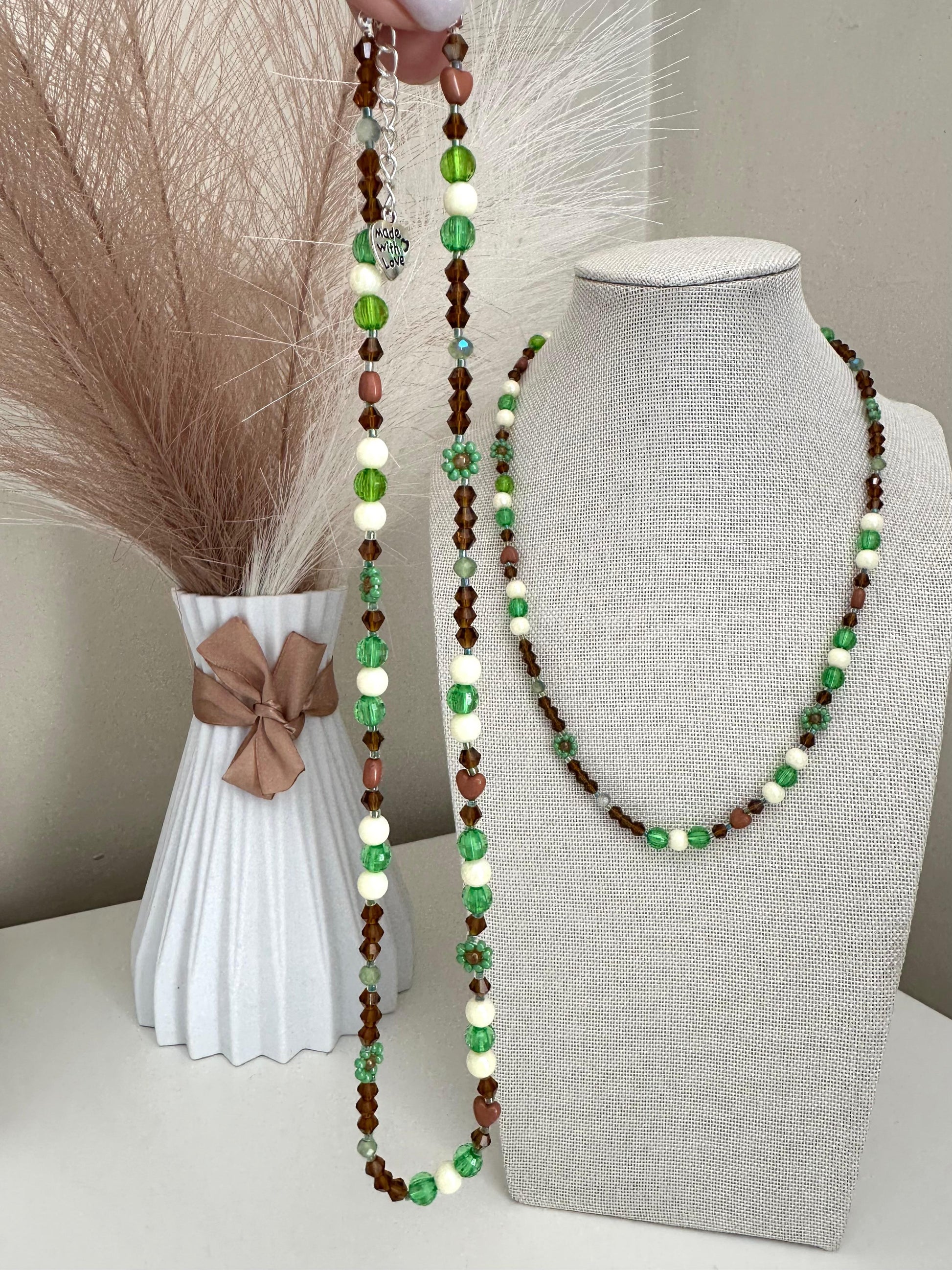 Handmade MORNING DEW necklace with brown and green glass beads and floral details on stainless steel chain