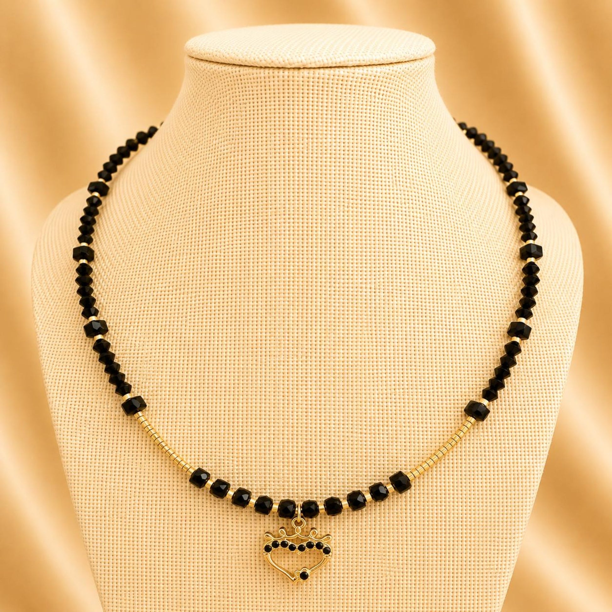 Handmade Midnight Passion necklace with black crystal beads, golden heart pendant, and 18K gold plated chain
