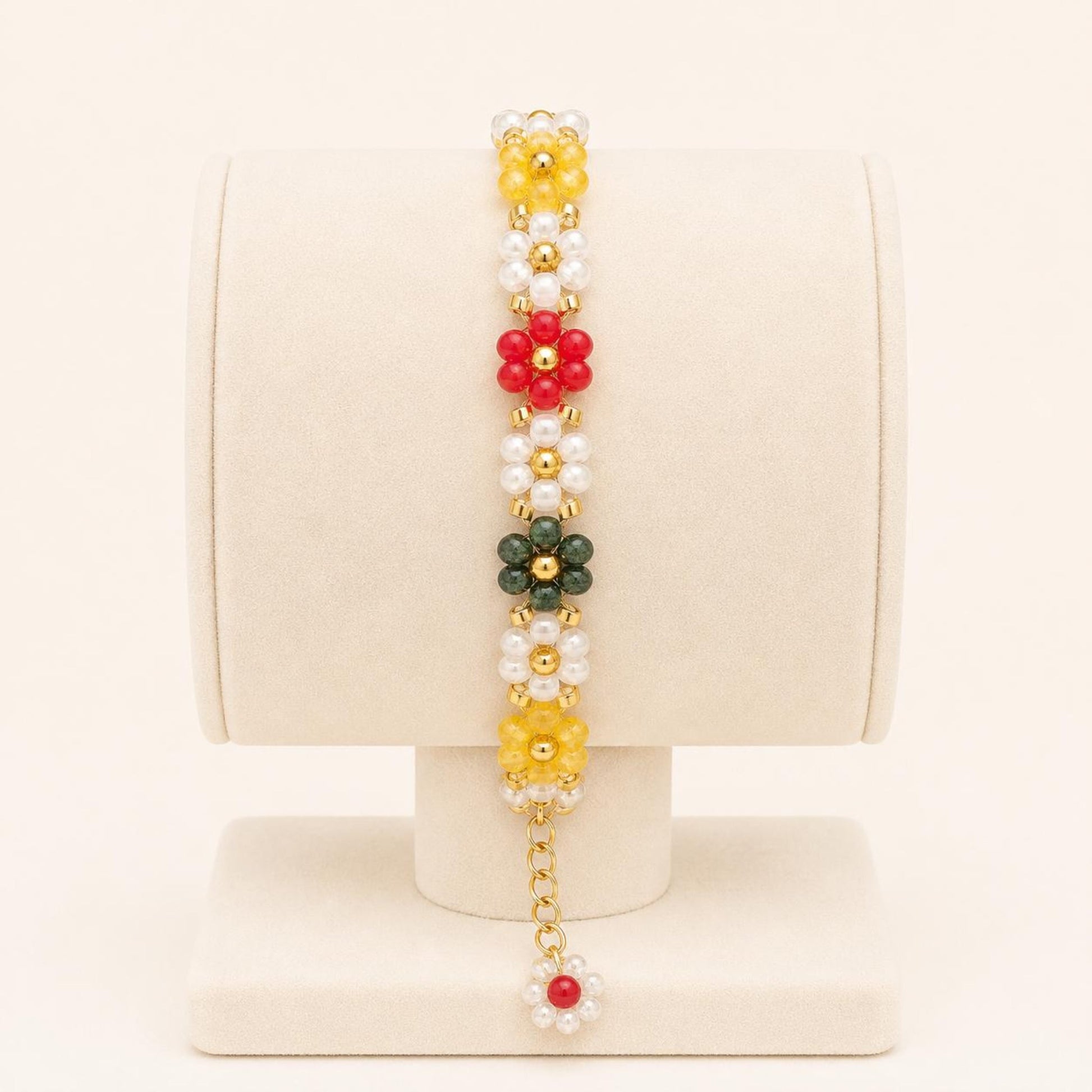 Colorful flower handmade bracelet with white, green, red, and yellow beads and gold accents on a nylon string