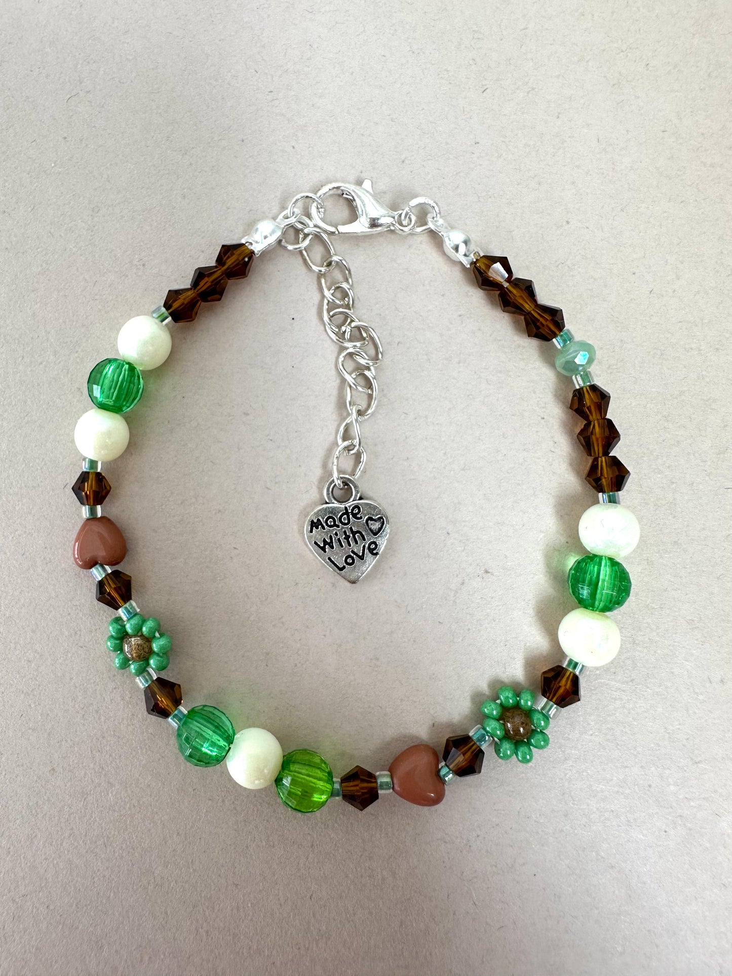 Handmade MORNING DEW bracelet with brown and green glass beads, floral details, and stainless steel clasp