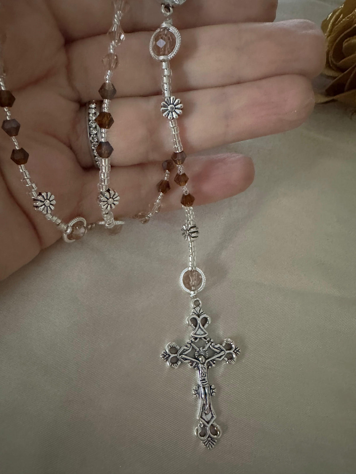Amber & Champagne Handmade Rosary with faceted amber and champagne crystal beads, silver-tone flower spacers, centerpiece and ornate crucifix