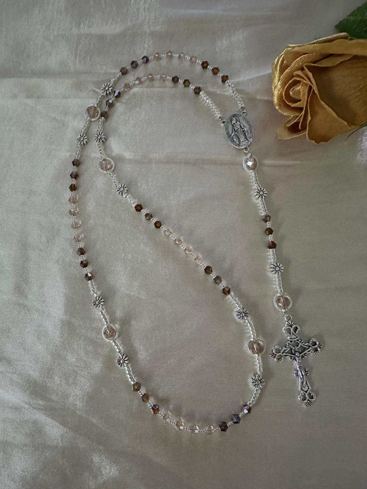 Amber & Champagne Handmade Rosary with amber and champagne faceted crystal beads, silver-tone flower spacers, medallion and crucifix.