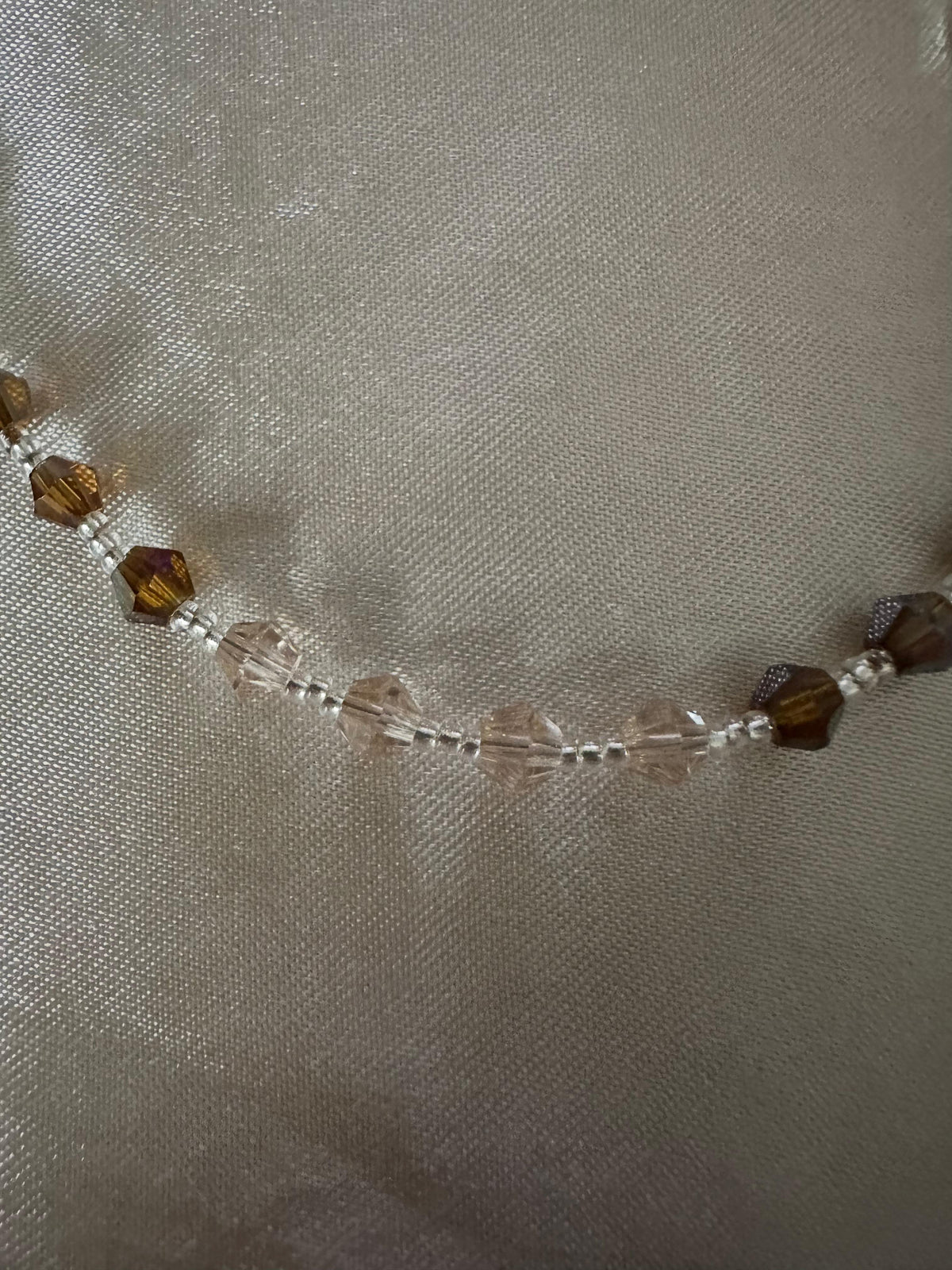 Amber & Champagne Handmade Rosary with faceted amber and clear champagne crystal beads, silver-tone spacers and settings.