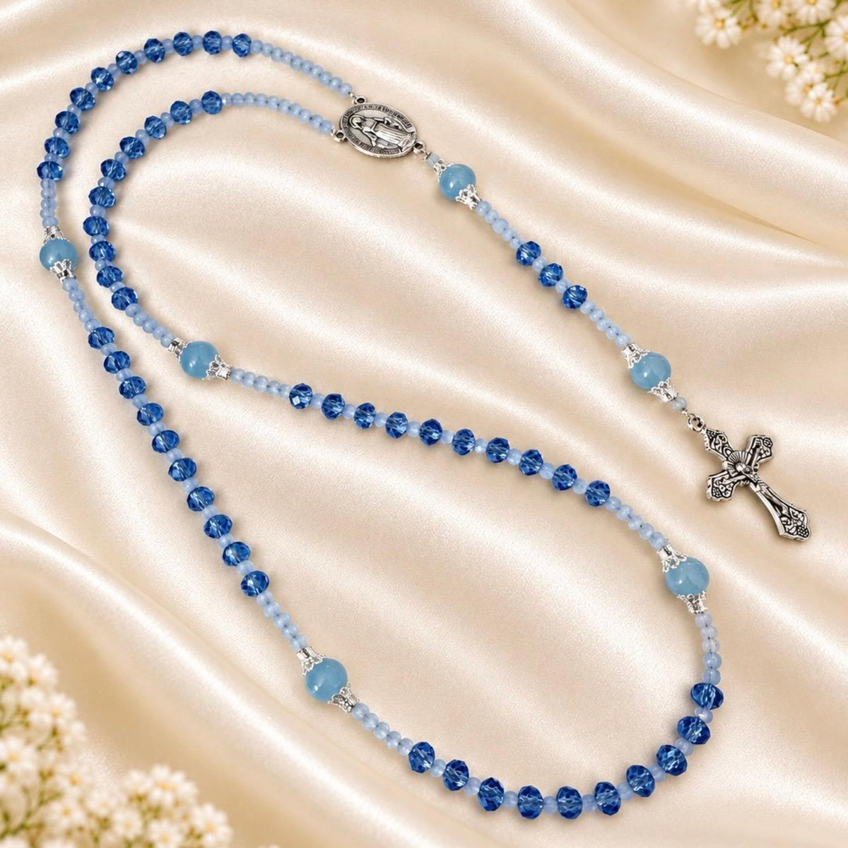 Blue Serenity Handmade Rosary with faceted blue and light blue glass beads, silver-tone filigree accents and crucifix