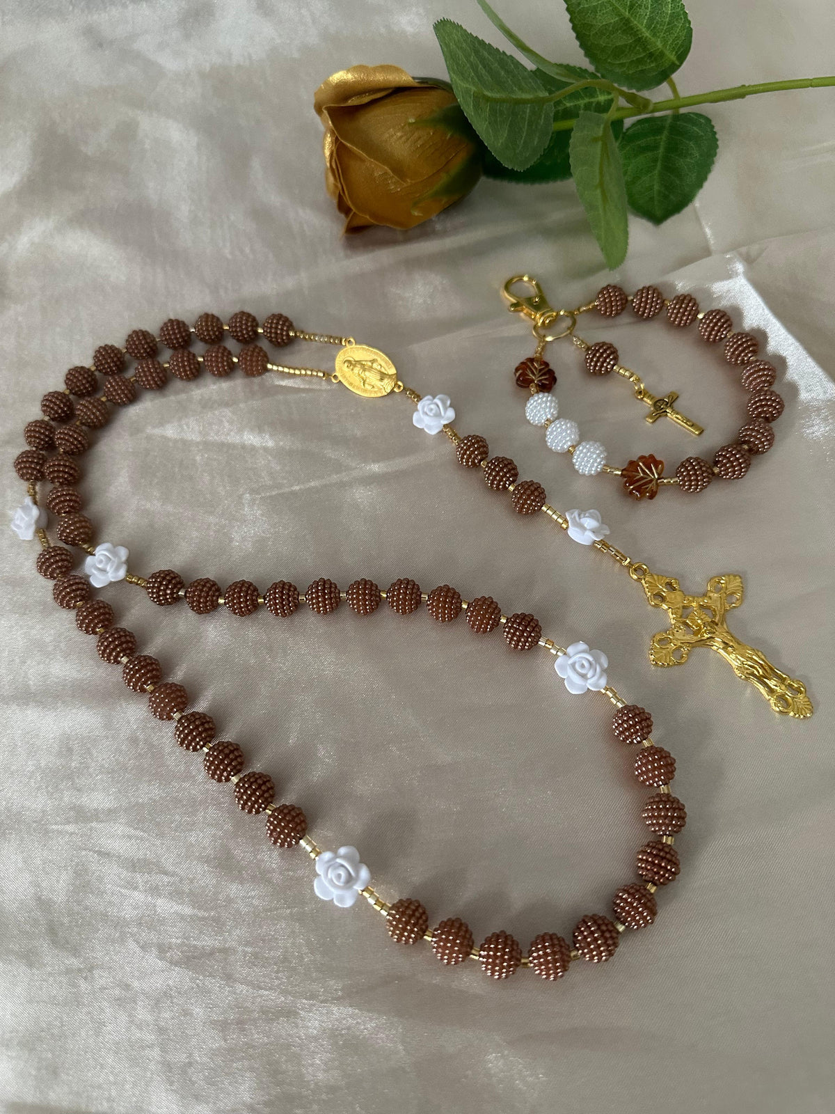Cocoa Grace Handmade Catholic Keychain with brown textured beads, white rose accents, gold-tone details and crucifix