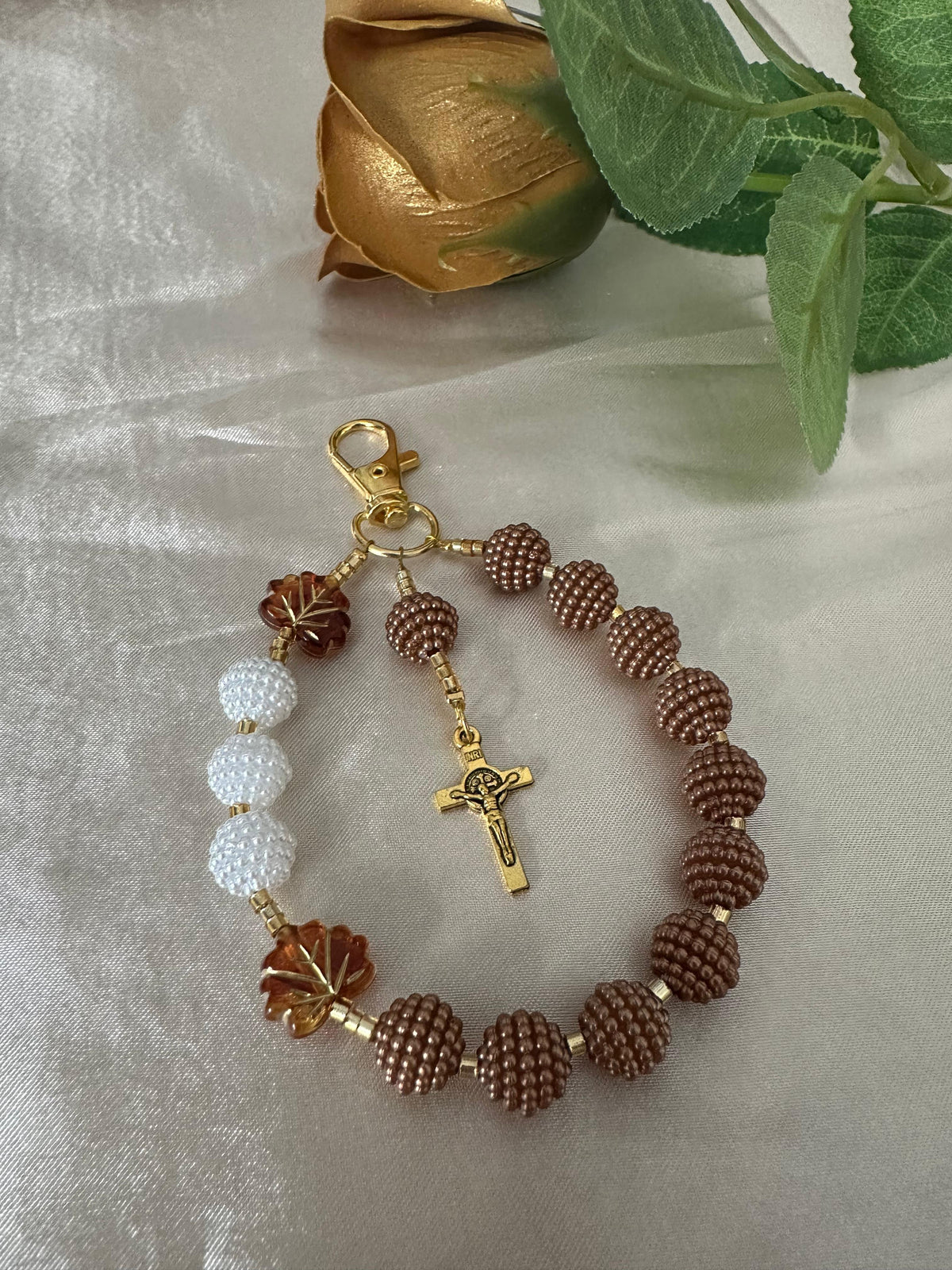 Cocoa Grace Handmade Catholic Keychain with textured brown and white beads, amber leaf accents, and gold-tone crucifix