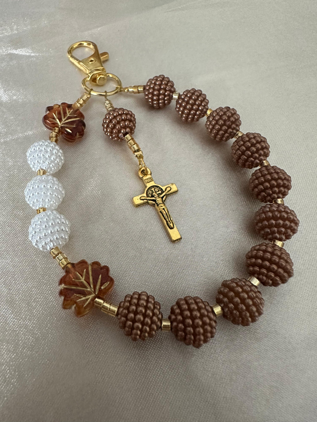 Cocoa Grace Handmade Catholic Keychain with textured brown and white beads, amber leaf accents and gold-tone crucifix