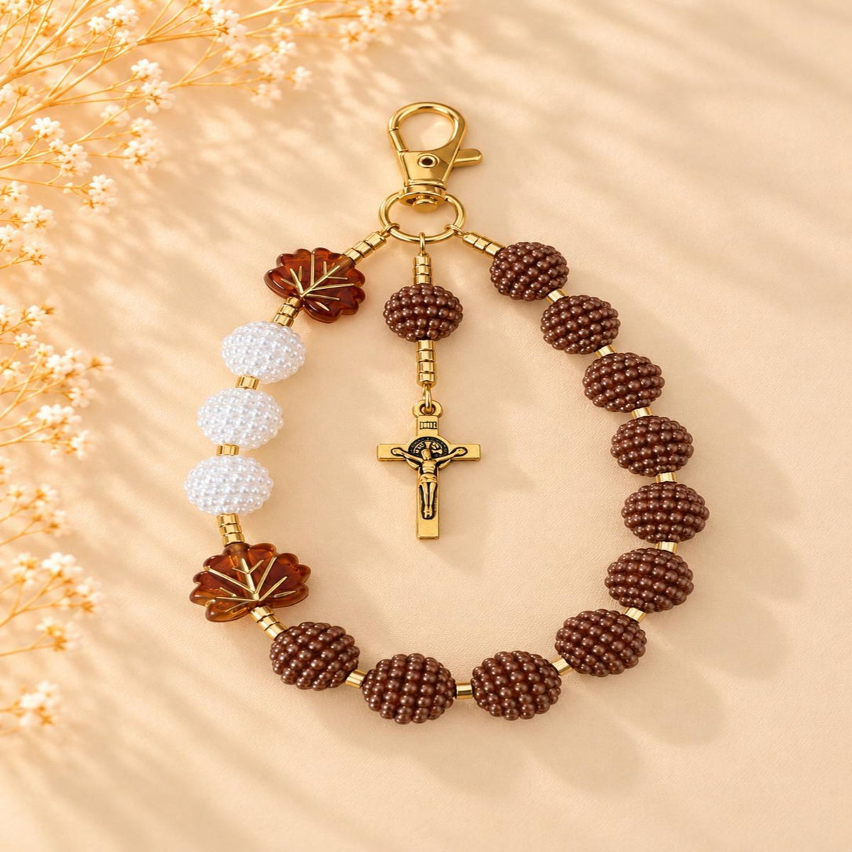 Cocoa Grace Handmade Catholic Keychain with textured brown and white beads, amber leaf accents and a gold-tone crucifix