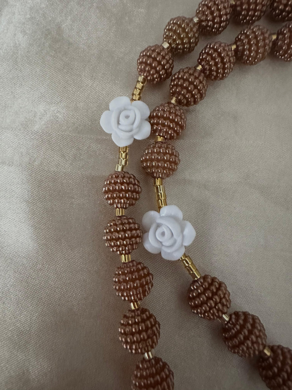 Cocoa Grace Handmade Rosary with textured brown beads, white rose-shaped beads, and delicate gold-tone accents.