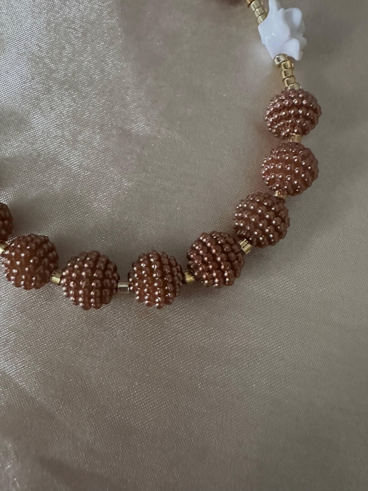 Cocoa Grace Handmade Rosary with textured cocoa-brown round beads, tiny gold-tone spacers and white rose-shaped beads.