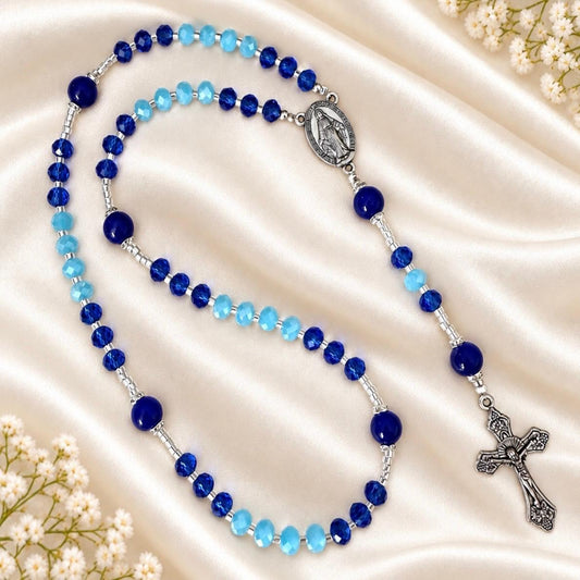 Handmade Rosary featuring indigo and baby blue crystal glass beads with silver-tone spacers, centerpiece, and crucifix