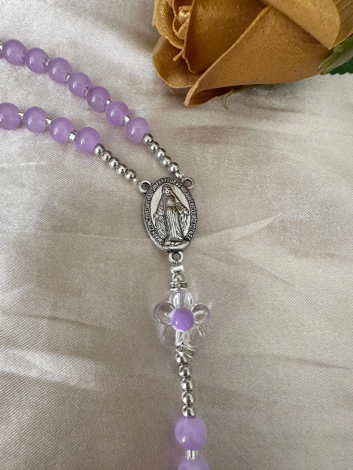 Lilac Blossom Handmade Rosary featuring lilac glass beads, silver-tone spacers with clear rhinestones, and a flower-shaped bead centerpiece