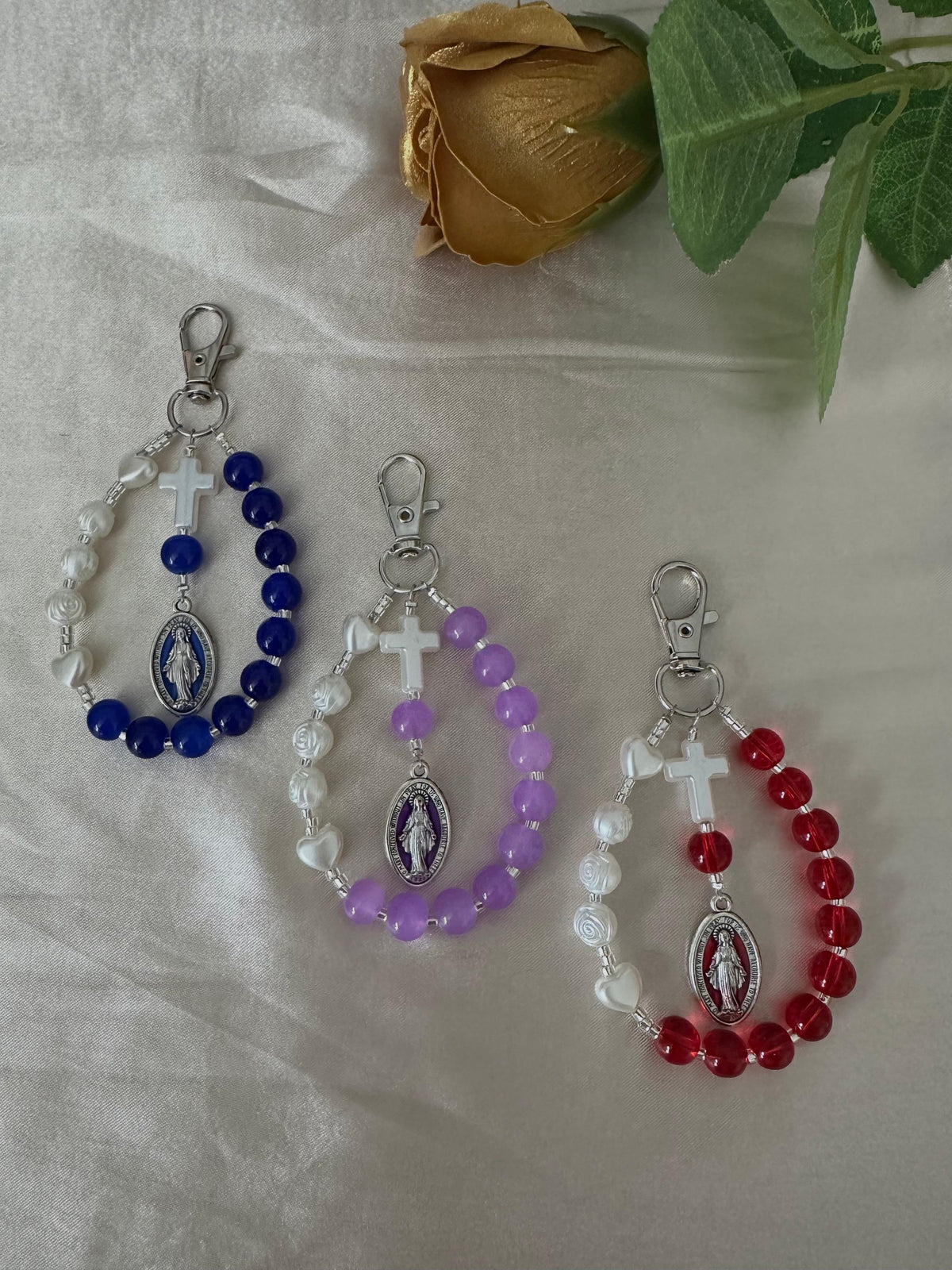 Mary’s Grace Handmade Catholic Keychain with glass beads in blue, purple and red, ivory cross and Mary medal.