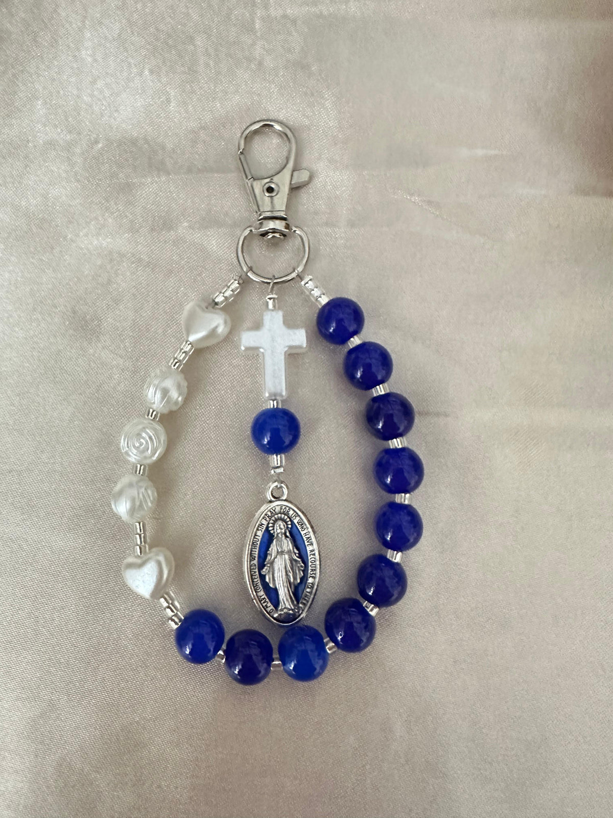 Mary’s Grace Handmade Catholic Keychain with indigo glass beads, ivory rose and heart beads, a cross, and silver-tone Mary medal.
