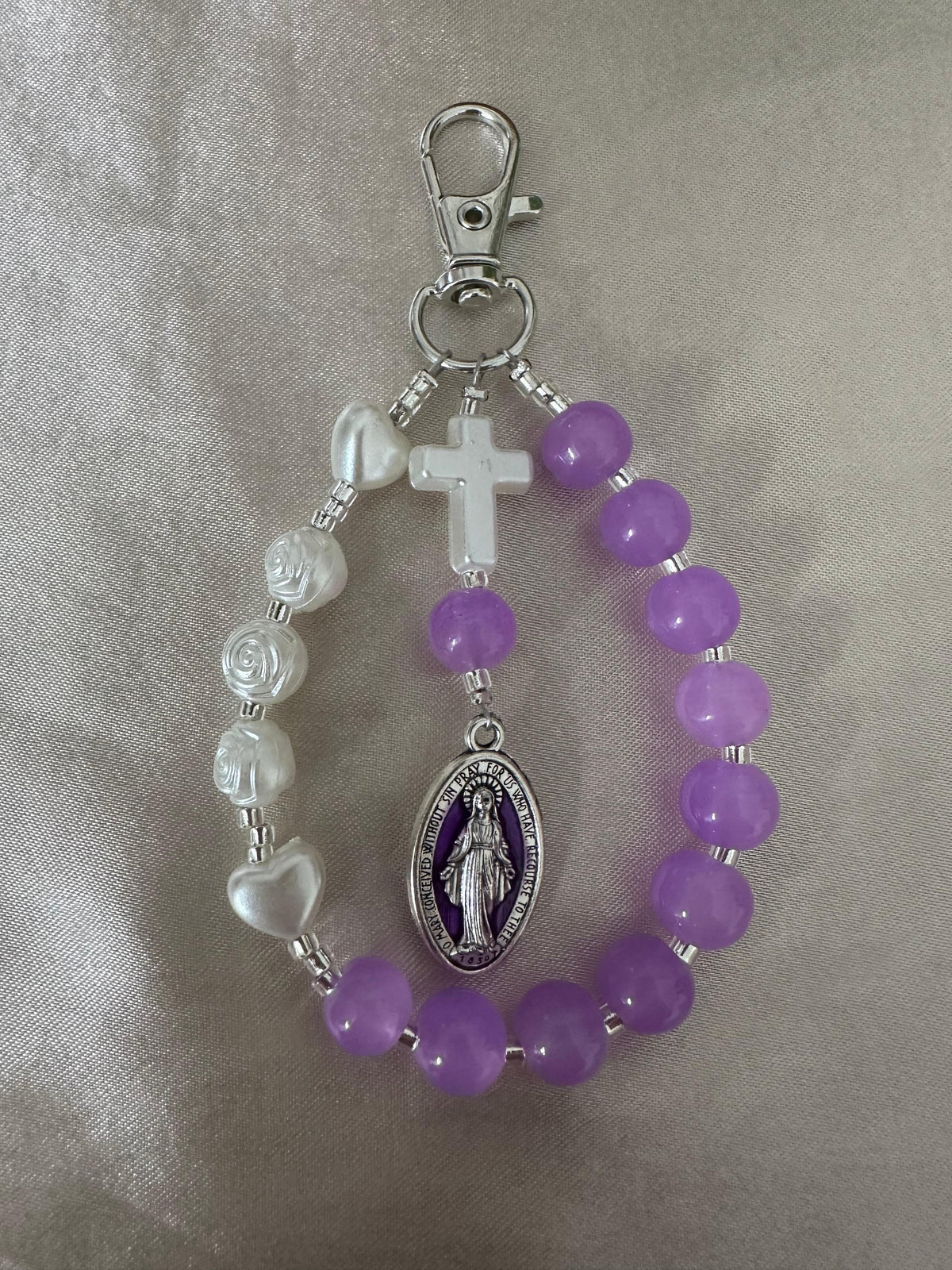 Mary’s Grace Handmade Catholic Keychain with purple glass beads, ivory faux pearls, a cross and silver-tone Mary medal