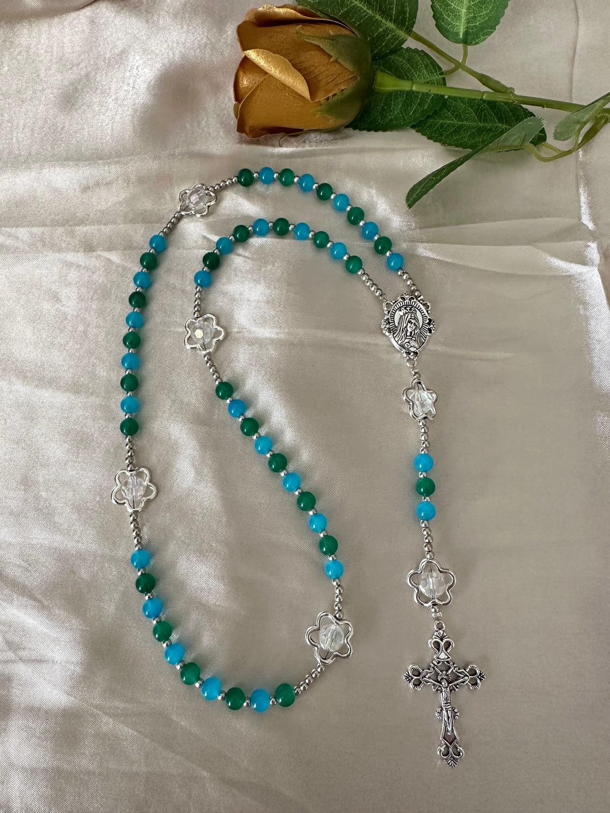 Ocean Bloom Handmade Rosary featuring green and turquoise glass beads, silver-tone floral accents, and a detailed silver crucifix