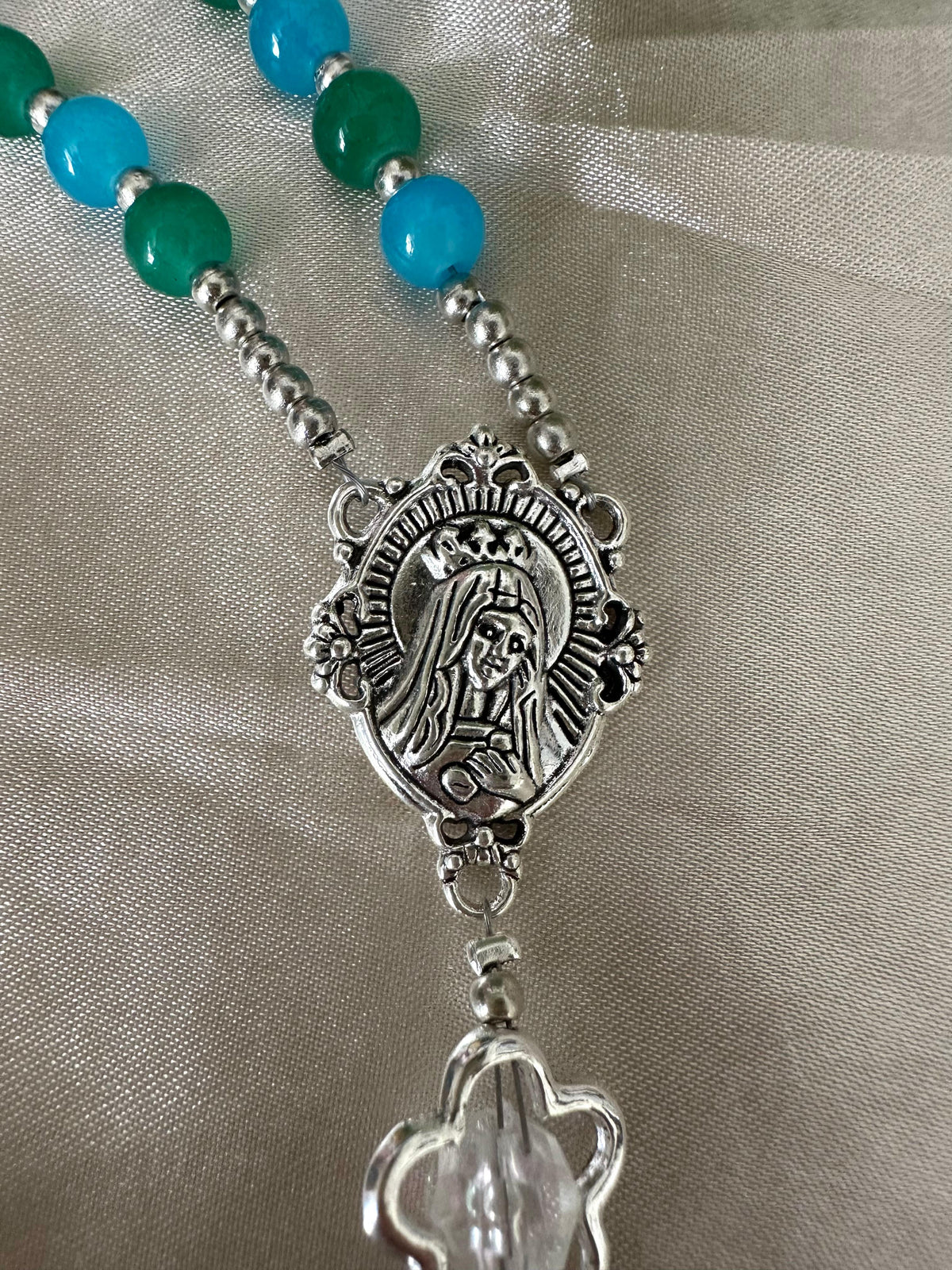 Ocean Bloom Handmade Rosary featuring green and turquoise glass beads and a detailed silver-tone medallion centerpiece