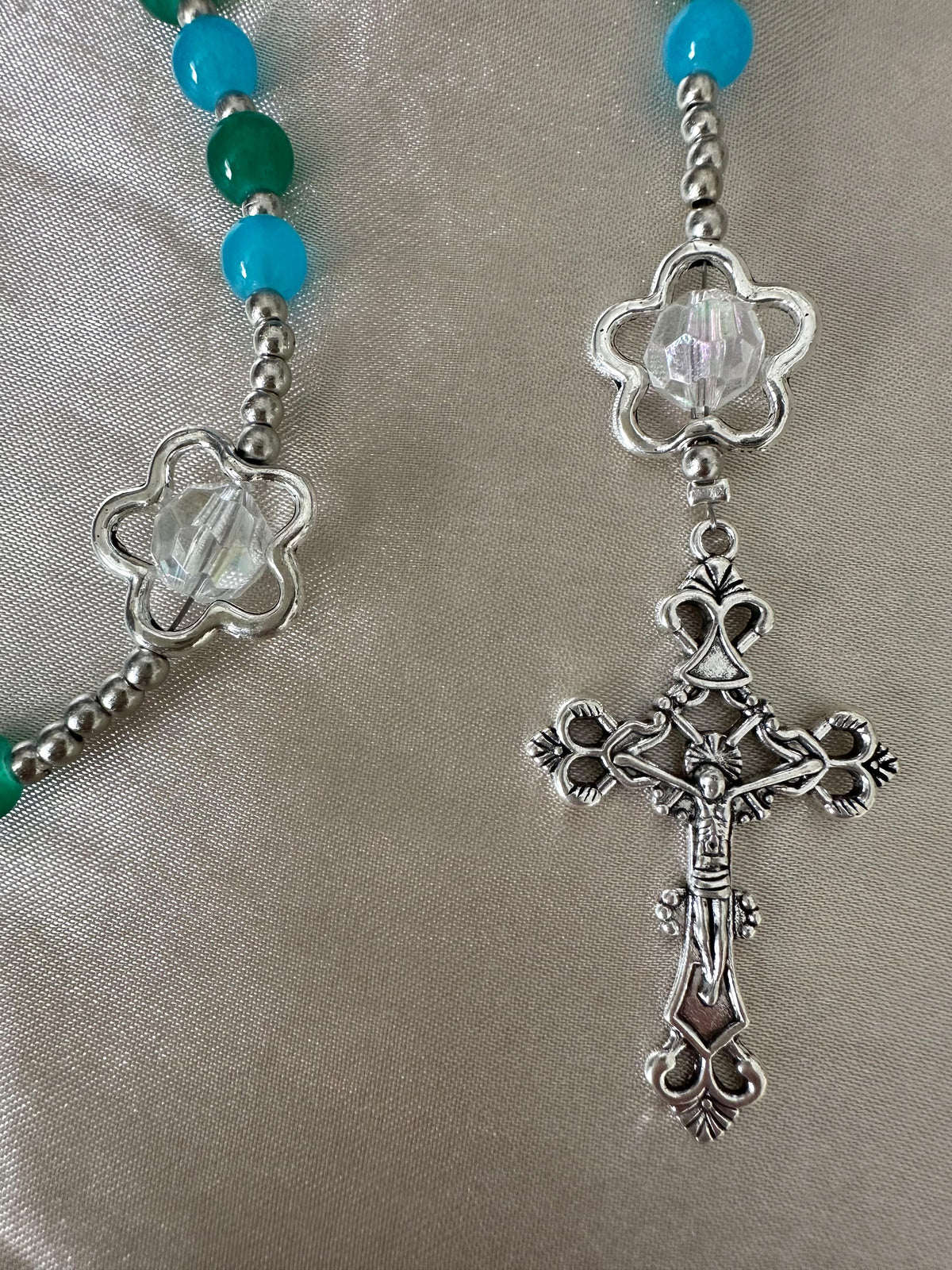 Ocean Bloom Handmade Rosary featuring turquoise and green glass beads, silver-tone flower-shaped and crucifix beads