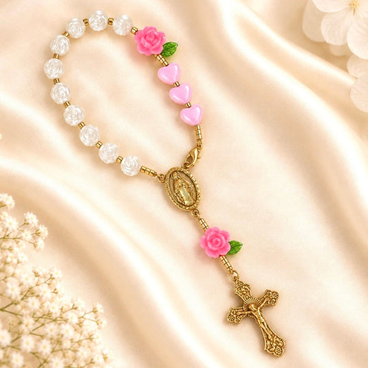 Pink Rose Mini Rosary with glossy white beads, pink heart beads, rose accents, green leaves, and gold-tone Mary centerpiece and crucifix