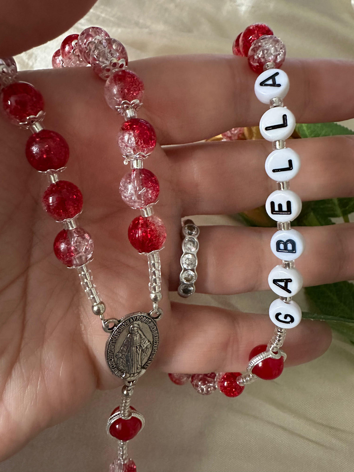Red Personalized Handmade Rosary with red and clear faceted glass beads, silver-tone accents, and white name beads