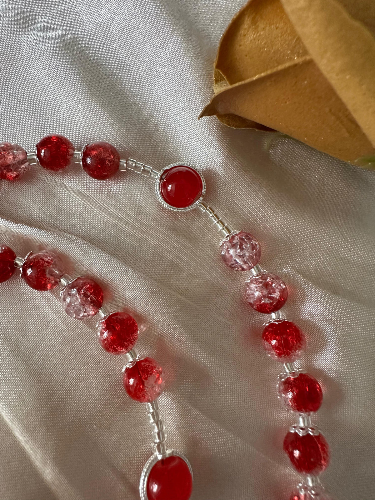 Red Personalized Handmade Rosary with glossy red and pale pink glass beads, silver-tone links, and a round red centerpiece