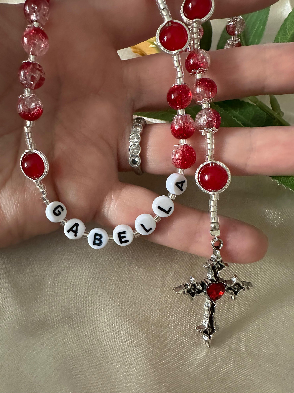 Red Personalized Handmade Rosary with red glass beads, silver-tone settings, white name beads, and ornate crucifix