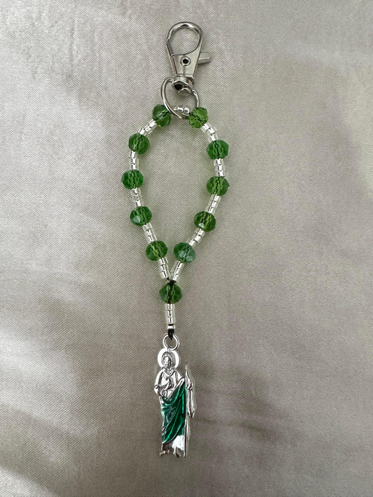 Sacred Hope Handmade Catholic Keychain with green faceted beads, silver spacers, and a silver-tone figure charm in a green robe